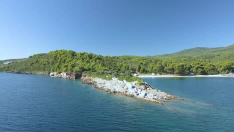 4K-drone-clip-over-a-rock-formation-in-the-tropical-blue-waters-of-Toroni-in-Chalkidiki