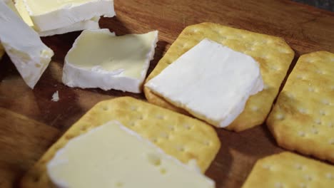 Closeup:-Pieces-of-Brie-cheese-placed-onto-salted-soda-crackers