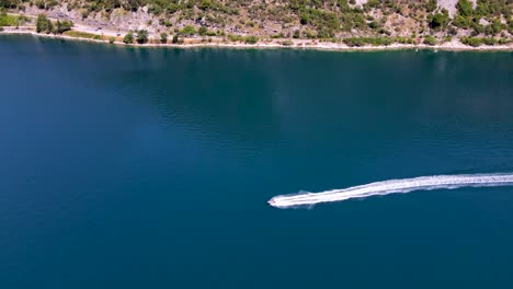 Aerial-View-Of-A-Motorboat-Quickly-Coming-Into-The-Bay-Of-Kotor