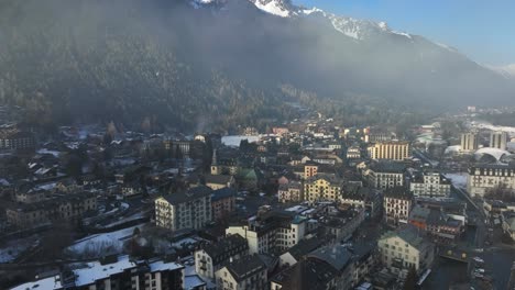 Aerial-Drone-fly-over-of-Chamonix-ski-town-on-a-bright-winter-day-with-fog
