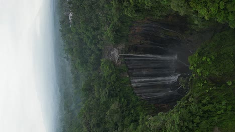 Vertical-format:-Aerial-descent-at-stunning-Java-Tumpak-Sewu-waterfall