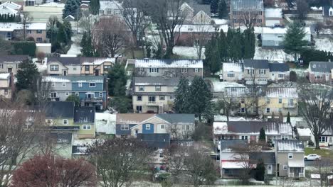 American-neighborhood-with-snowy-roofs-located-on-hill-in-winter