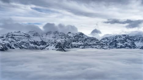 Mystifying-sea-of-fog-with-Swiss-alps-ridgelines-and-clouds-rolling-across-clean
