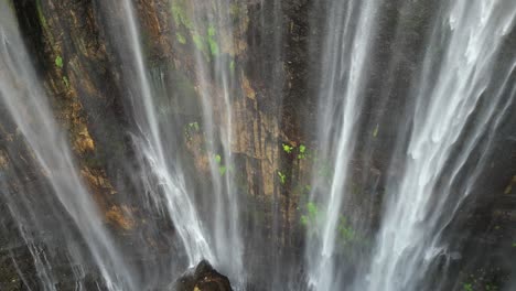 Unique-aerial-view-of-wispy-Tumpak-Sewu-waterfall-grotto-on-Java,-IDN