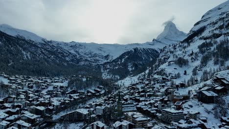 Slow-drone-aerial-of-the-matterhorn-over-the-ski-town-and-resort-of-Zermatt,-Switzerland-in-the-Swiss-Alps-mountains