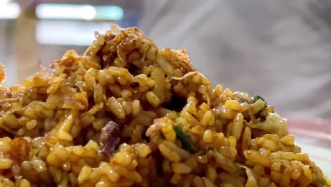 Close-up-shot-of-the-fried-rice-on-the-plate-was-still-hot-and-emitting-smoke