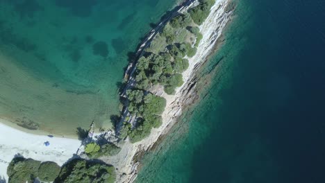 Overhead-4K-drone-clip-over-a-rock-formation-in-the-tropical-blue-waters-of-Toroni-in-Chalkidiki