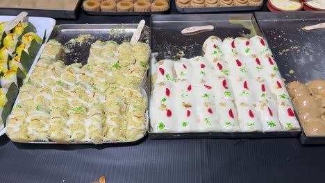 Closeup-view-of-traditional-authentic-Bengali-sweets-kept-at-a-sweet-shop-in-Kolkata,-India
