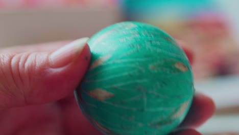 Closeup-of-Artist-Drawing-Ornate-Traditional-Designs-on-a-Green-Easter-Egg