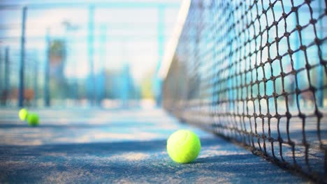 Padel-court,-ball,-net-and-empty-field-close-up-view-in-slow-motion-with-depth-of-field