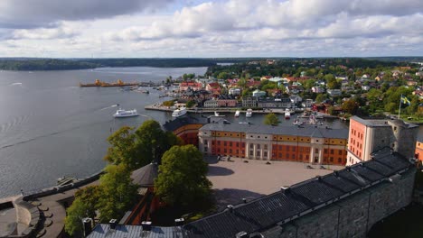 Drone-shot-ascending-behind-the-Vaxholm-Fortress-to-reveal-the-town-of-Vaxholm-in-Sweden