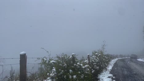 Pov-shot-from-car-passing-through-snowfall-blizzard-along-Mountain-road,-Winter-Storm