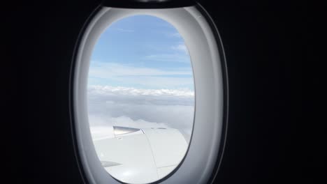 Flying-Over-White-Clouds,-View-From-Airplane-Window---POV