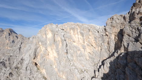 FPV-racing-drone-flying-across-the-Italian-Dolomites-extreme-mountain-range-rocky-ridge