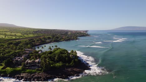 Panoramic-aerial-establishes-black-rocky-point-with-long-strong-waves-breaking-on-reef