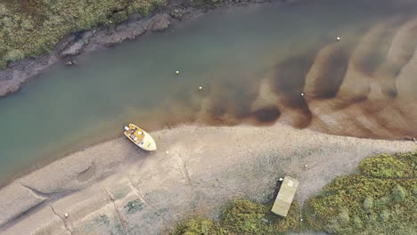 Top-down-aerial-footage-slowly-descending-over-an-estuary