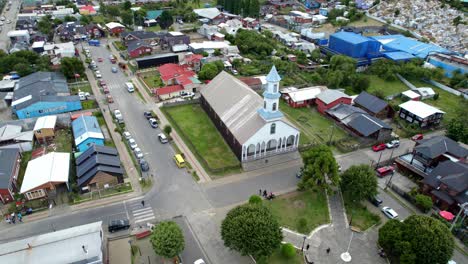 Aerial-Drone-Fly-Above-Dalcahue-City-Streets-Chiloé-Chile-Patrocinio-Lady-Church-during-Daylight,-Panoramic-Establishing-Shot