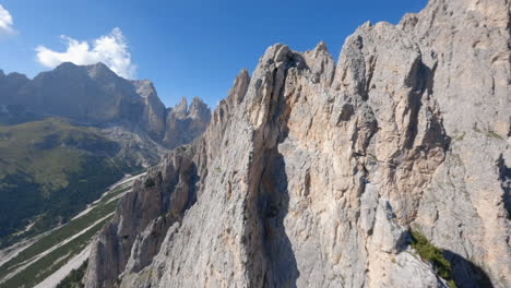 FPV-drone-following-sharp-rocky-ridge-of-the-Italian-Dolomite-majestic-mountain-range