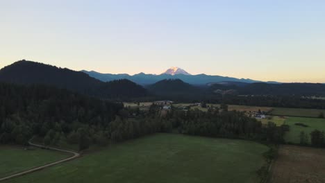 A-wide,-rising-drone-view-of-Enumclaw-Farms-in-the-early-morning-near-the-base-of-Mt