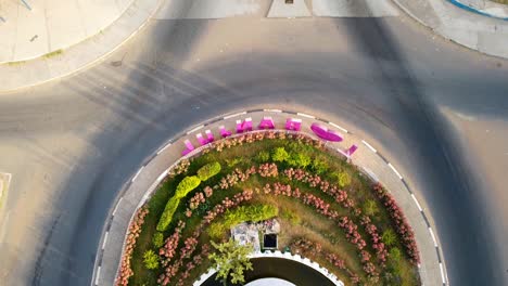 Aerial-tilt-up-view-from-fountain-of-arch-22-entrance-of-Banjul-city,-Gambia-with-I-love-Banjul-letters