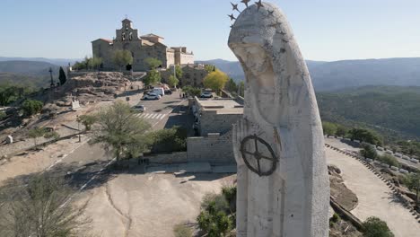 Statue-of-Virgin-Mary-Spanish-pilgrimage-destination-in-Andalusia-landscape-AERIAL-PULL