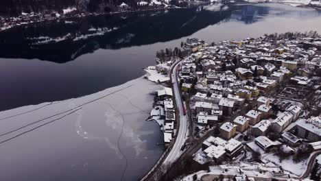 Sensational-aerial-shot-of-Zell-Am-See-lake-and-town-with-train-passing-by