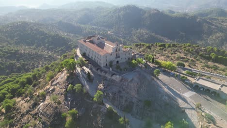 AERIAL-reveal-of-the-hilltop-of-Our-Lady-of-Cabeza-basilica-and-Andalusia-landscape-Spain