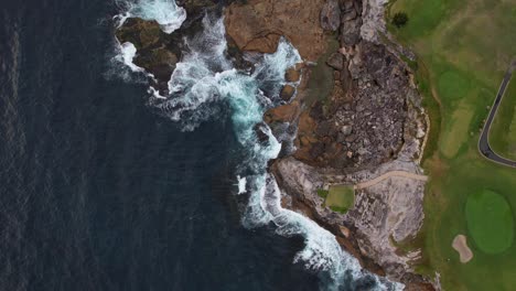 Waves-Splashing-On-Rocky-Shore-Of-Little-Bay-Beach-In-Sydney,-New-South-Wales,-Australia---Aerial-Top-Down