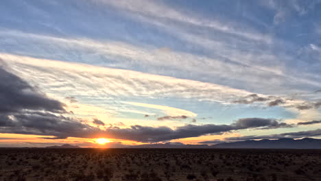 Dawn-breaks-over-Mojave-Desert-with-dynamic-cloud-play,-timelapse
