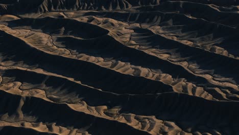 Mudstone-formations-of-wavy-sharp-rocks-ridges-at-Factory-Butte-canyon-in-USA