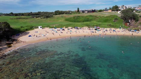 Little-Bay-Beach-With-Tourists-Enjoying-During-Summer-Holidays-In-Sydney,-New-South-Wales,-Australia---Aerial-Drone-Shot