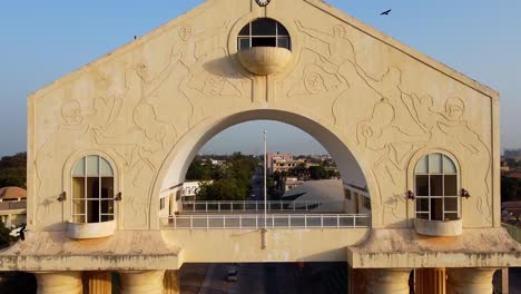 Beautiful-aerial-close-up-ascending-view-of-arch-22-monument-building-at-entrance-of-Banjul-city-gateway,-Gambia