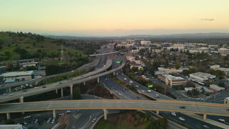 High-aerial-view-of-heavy-traffic-flow-on-freeway-highway-overpass,-Walnut-Creek