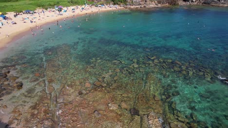Tourists-At-Little-Bay-Beach-With-Clear-Turquoise-Water-In-Sydney,-New-South-Wales,-Australia---Aerial-Shot
