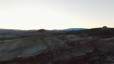 Birdseye-view-of-people-visiting-Bentonite-Hills-travel-destination-in-Utah-at-sunset,-USA