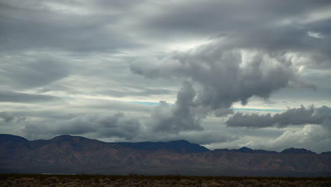 Dramatic-clouds-over-Mojave-Desert-with-mountain-backdrop,-timelapse