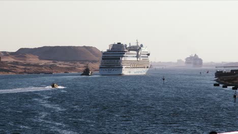Kreuzfahrtschiffe-Fahren-An-Einem-Sonnigen-Tag-Mit-Unterstützung-Eines-Schleppers-Durch-Den-Suezkanal
