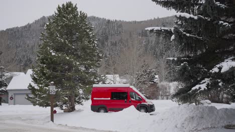 Parked-Red-Van-in-Village-and-White-Snowy-Mountain-Landscape-on-Cold-Winter-Day