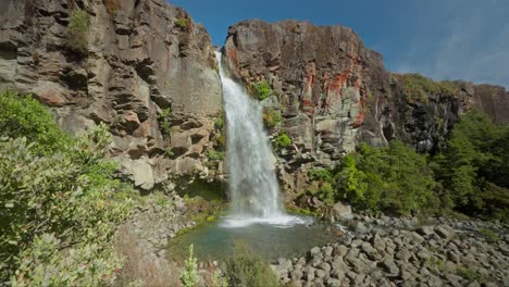 Stunning-Taranaki-waterfall-with-tall-volcanic-cliff-in-New-Zealand,-no-people
