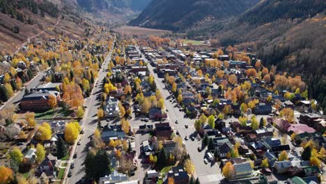 Pullback-drone-shot-over-main-street-in-telluride,-CO-with-fall-colors