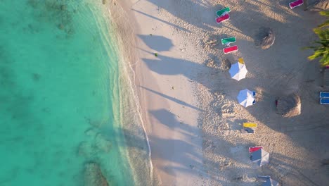 Drone-top-down-rising-above-white-sandy-shores-of-Daaibooi-beach-Curacao