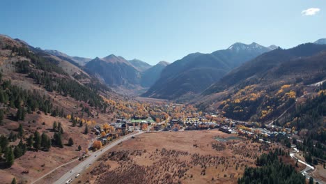 Distant-pullback-drone-aerial-view-of-Telluride,-CO-in-the-fall-on-a-sunny-day