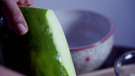 Using-a-peeler-to-peel-green-skin-from-Green-and-ripe-yellow-organic-fresh-papaya-pawpaw
