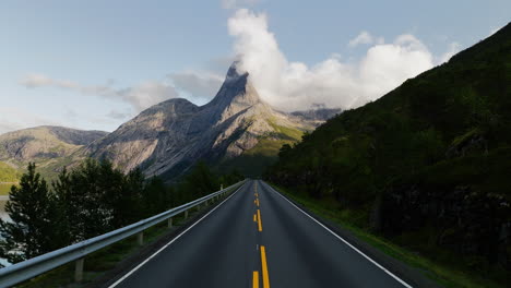 Empty-asphalt-road-leads-to-epic-morning-view-of-majestic-Stetind-Norway