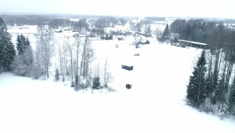 Aerial-view-of-town,-frozen-landscape-adorned-with-serene-blanket-of-snow