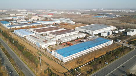 Aerial-view-of-a-Chinese-factory-located-on-the-industrial-outskirts-of-Linyi,-Shandong-Province,-China-on-a-sunny-day