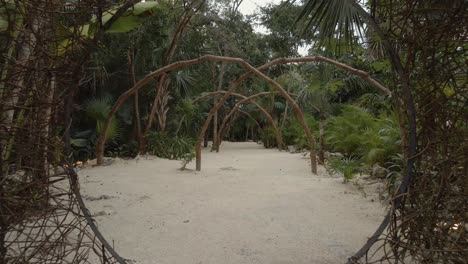 drone-movement-backwards-of-a-natural-hut-on-a-beach-between-palm-trees-in-the-jungle