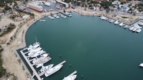 San-jose-del-cabo-marina-with-moored-yachts,-adjacent-beaches-and-coastal-town,-aerial-view