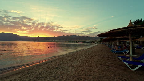 Stunning-sunset-over-the-Red-Sea,-tranquil-atmosphere-on-beach-of-Aqaba,-Egypt