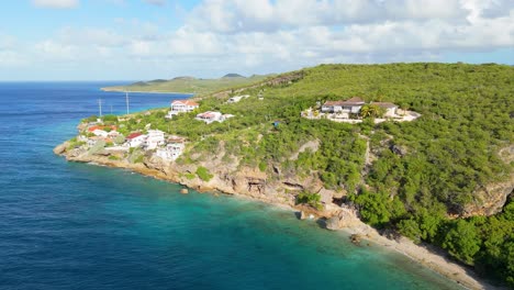 Playa-Hundu-and-stunning-beautiful-coastal-village-homes-looking-over-Caribbean-ocean,-Curacao
